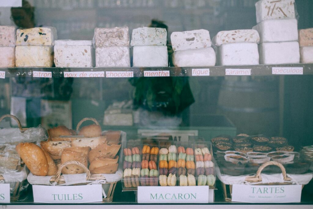 Assorted yummy sweets and bakery products places on counter of confectionery shop in daytime