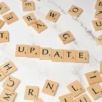 Scrabble letters spelling the word update on a white table