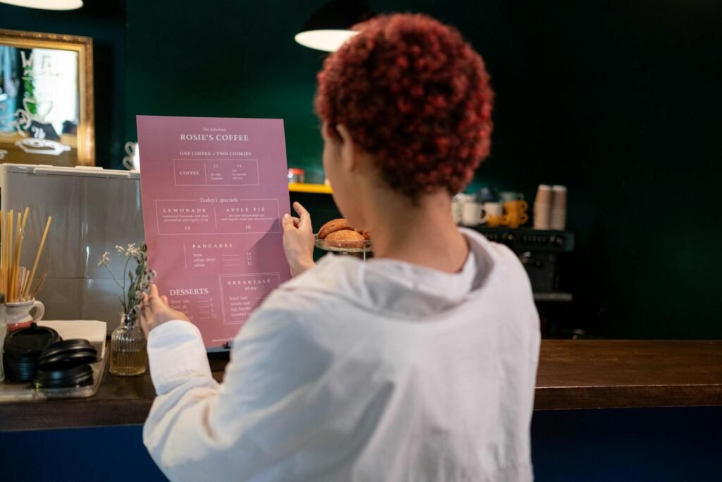 A Woman in White Long Sleeves Looking at a Food Menu