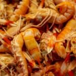 A vibrant pile of fresh shrimp with shells and antennae intact, showcasing the key ingredient for a quick and flavorful pan-seared seafood recipe.