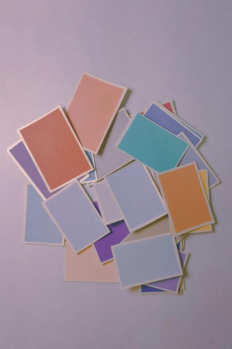 A scattered collection of colorful card-sized rectangles on a soft background, resembling a palette of modern icon designs.
