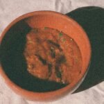 A small glass bowl filled with rich, red homemade Tex-Mex paste, ready to be used.