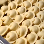 Homemade dumplings packed in a container for freezer storage